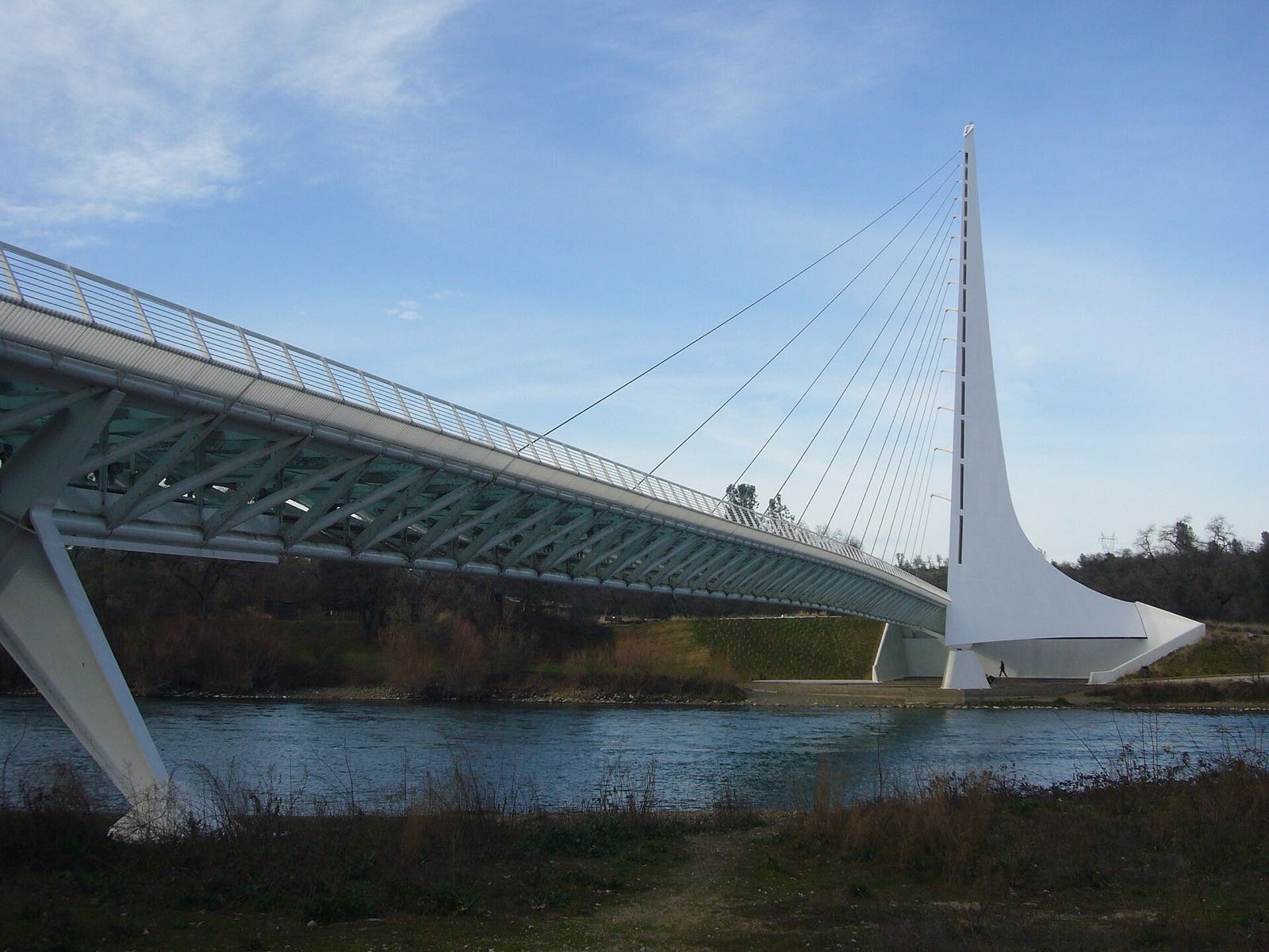 The Sundial Bridge, a glass-decked pedestrian bridge with a tall white pylon, spanning the Sacramento River in Redding, Shasta County, California